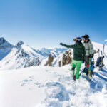 Man and woman at the top of a mountain during backcountry skiing in Baqueira Beret Pyrenees mountains Catalonia Spain spotlight on healthy aging
