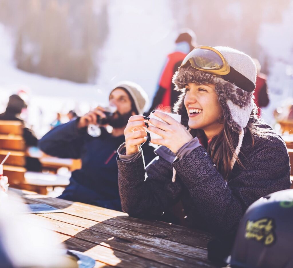 Happy skiers talking on a break in a cafe at mountain. sober curious
