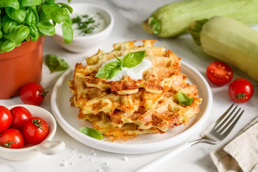 Zucchini cheese waffles with sour cream sauce with garlic and dill. Selective focus