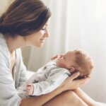 Loving mom carrying of her newborn baby at home. maternal mental health