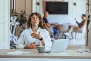 Woman Practicing Relaxation and Mindfulness in a Modern Workplace Setting