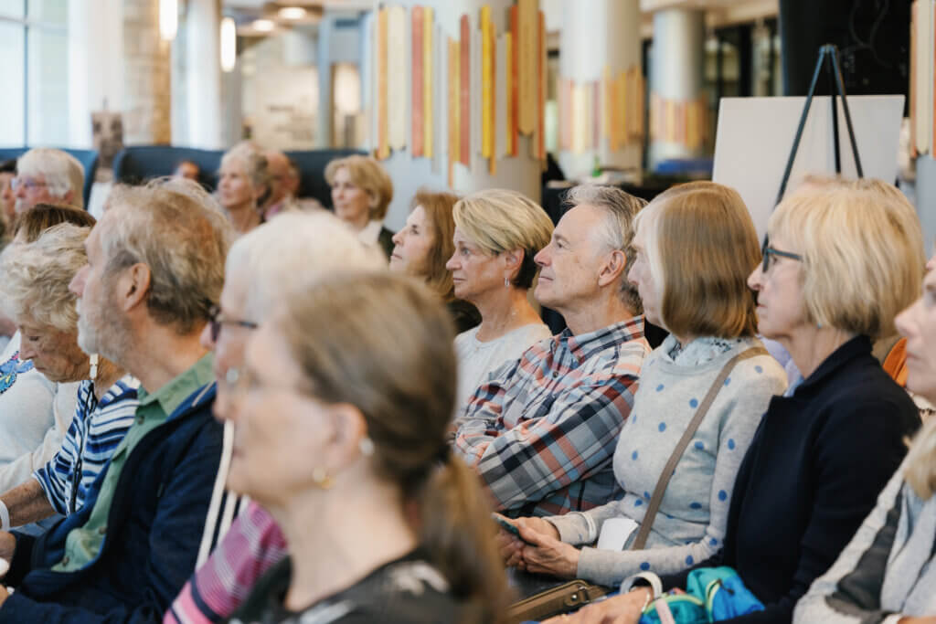 people sitting in chairs at an event