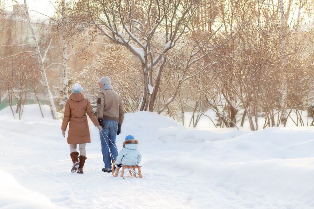 family out in the snow on a winter day taking advantage of bright light therapy for anxiety and seasonal affective disorder