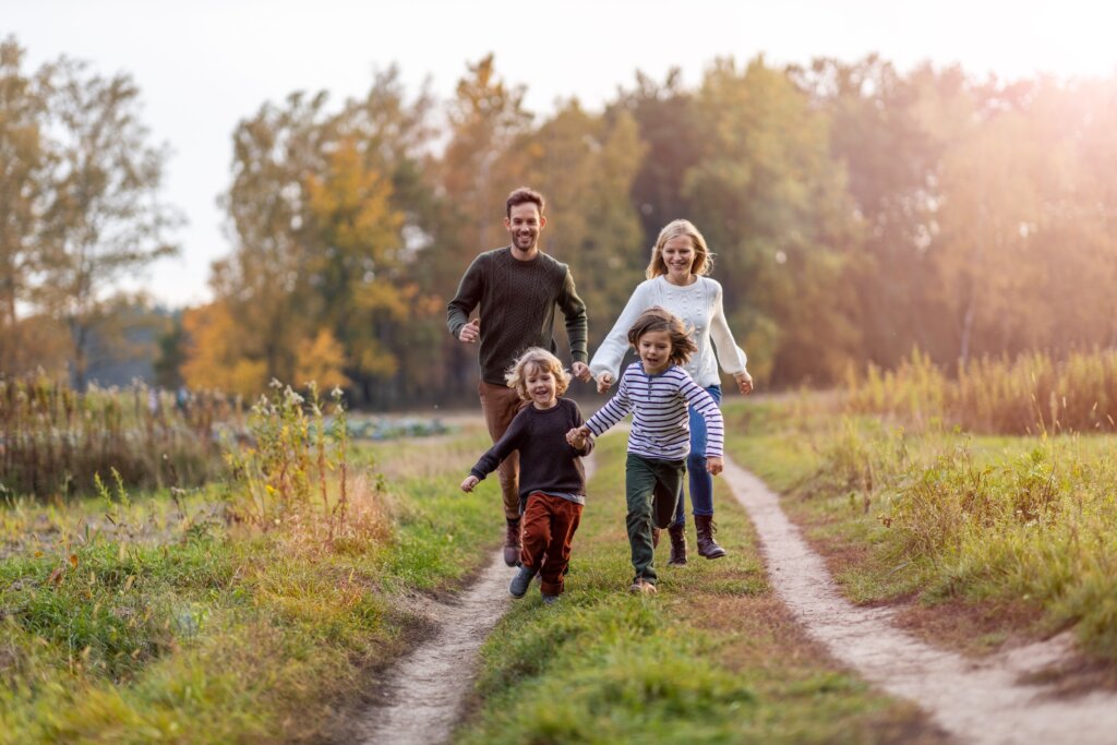 family with two young kids going on an outdoors excursion during their digital detox vacation
