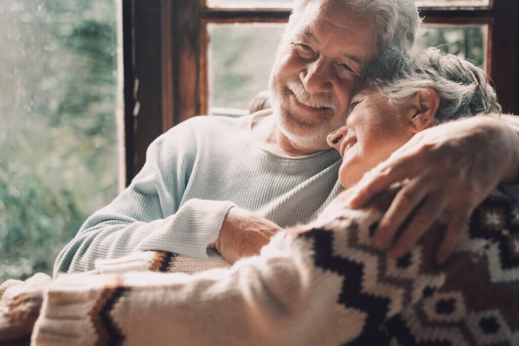 man smiling and comforting his wife with an embrace