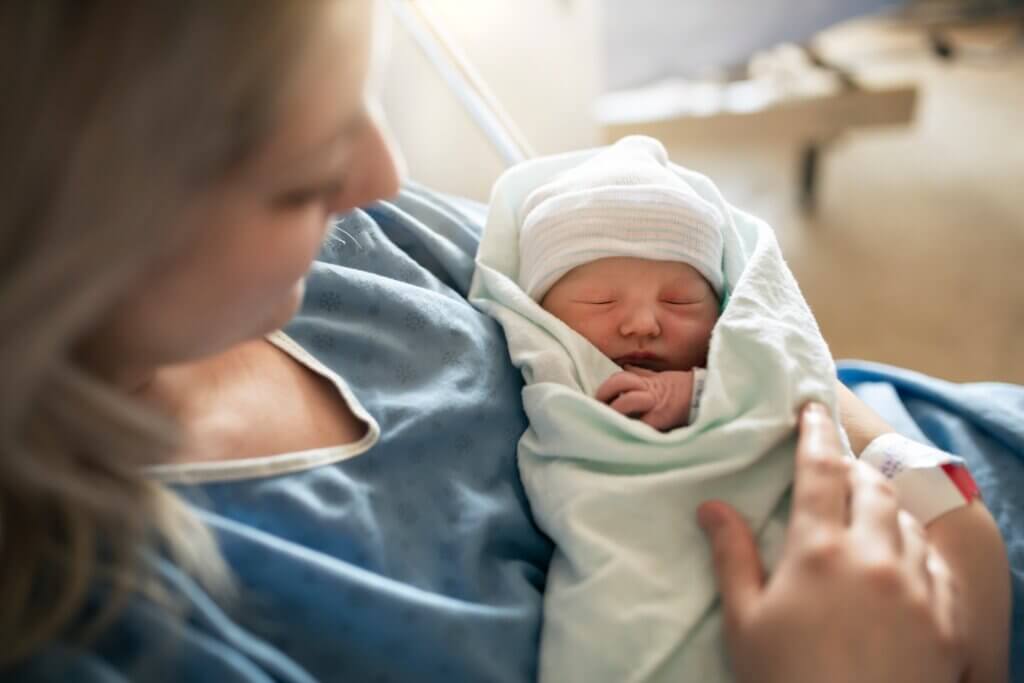 mom with postpartum brain fog holding her newborn baby in a cozy blanket