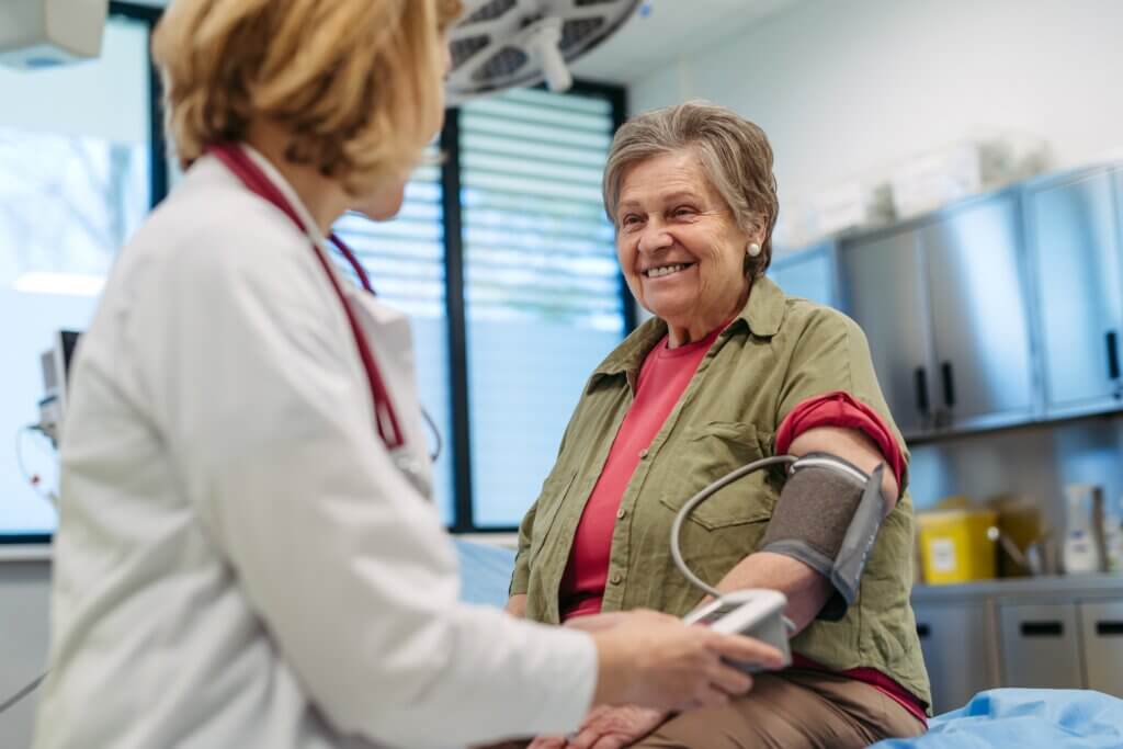 woman taking the blood pressure of a patient in a medical clinic