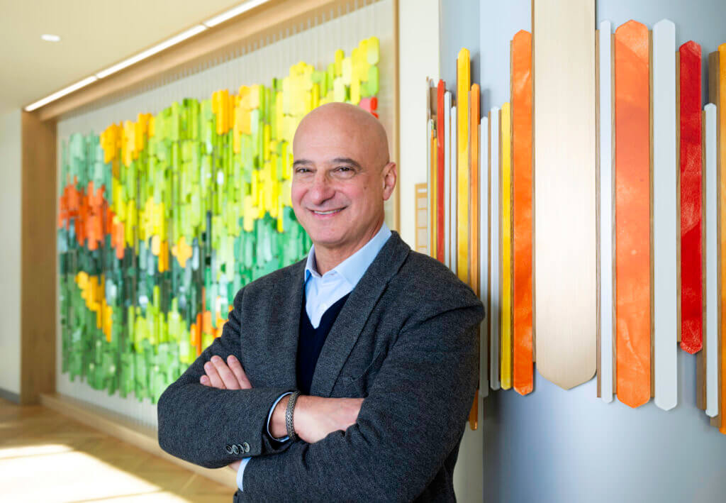 image of Dr Richard Becker standing in the lobby of Aspen Valley Hospital smiling at the camera with his arms crossed over his chest
