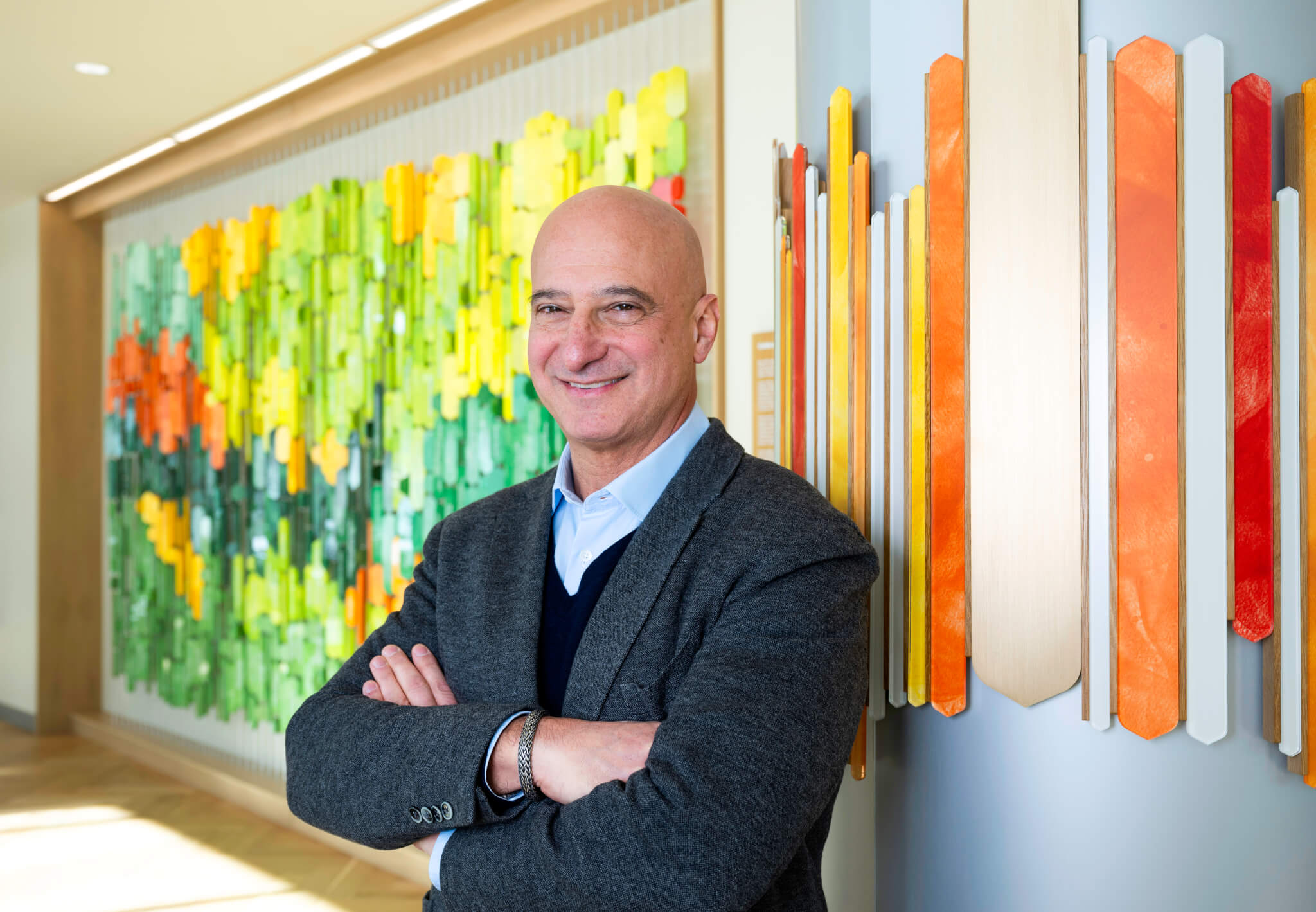 image of Dr Richard Becker standing in the lobby of Aspen Valley Hospital smiling at the camera with his arms crossed over his chest