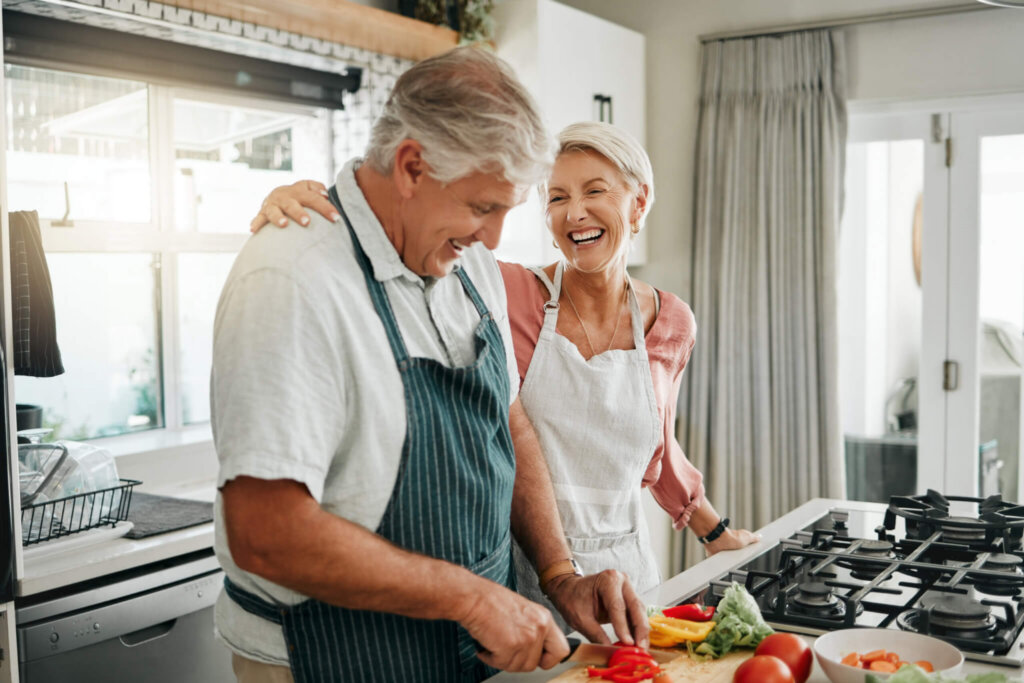 couple cooking in their kitchen together with high fiber foods to improve their digestive and gut health
