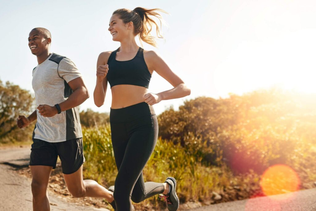 couple running together on a sunny morning in a hillside landscape