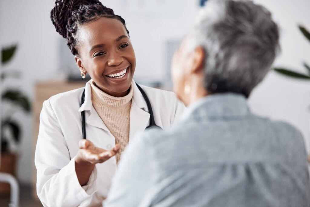 female doctor smiling at a patient as she has a digestive health consult with them
