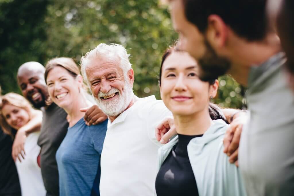 people standing in a line with arms around their shoulders