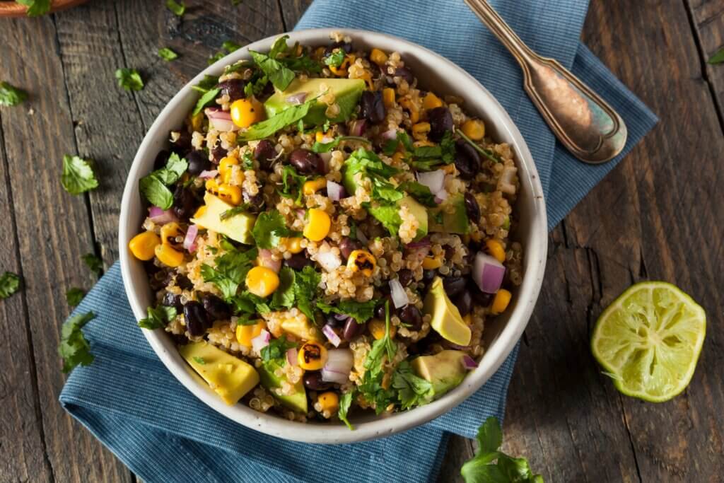high fiber quinoa corn and avocado bowl showcasing several of the best foods for colon health and cancer prevention
