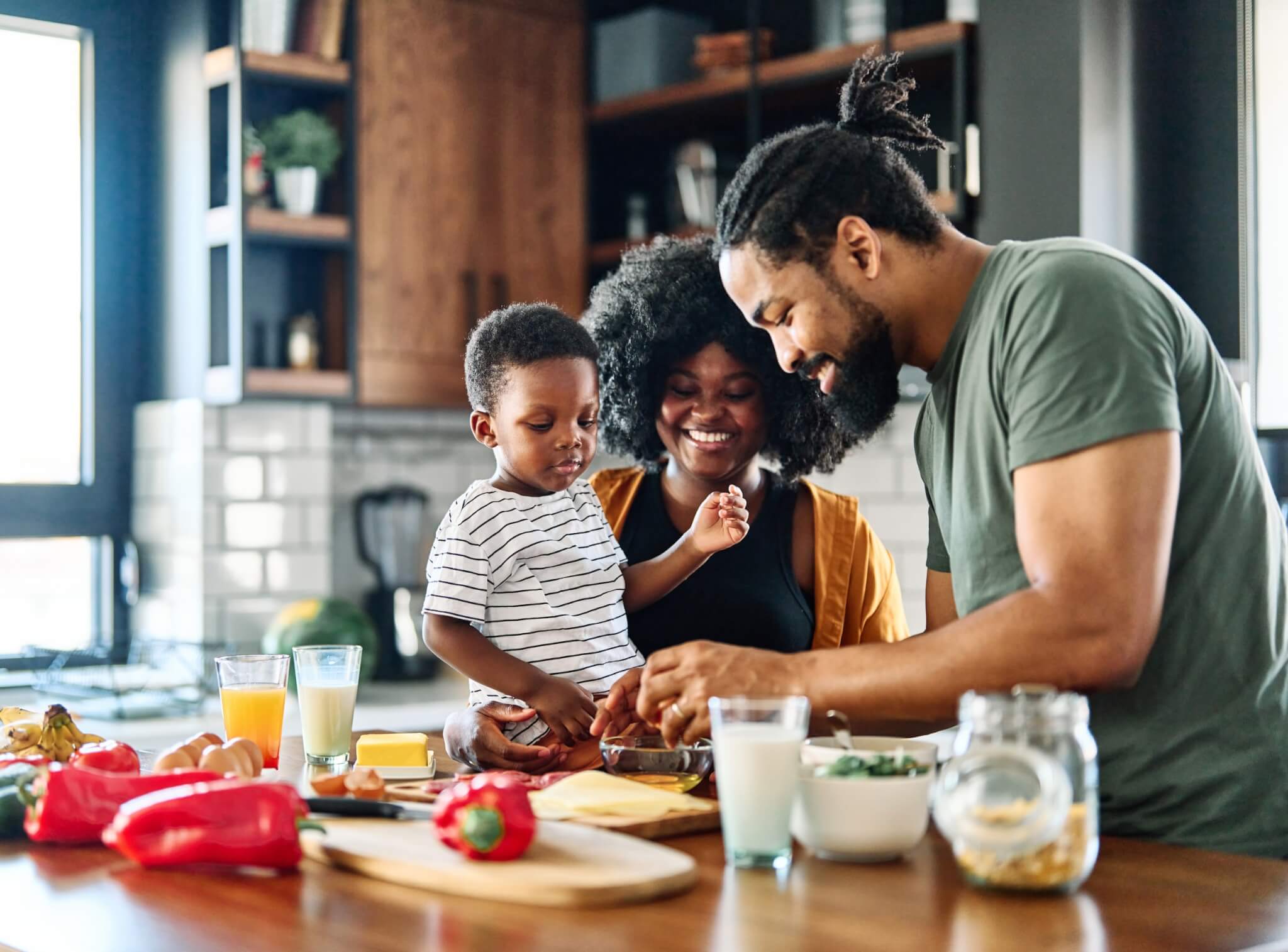 young family cooking in the kitchen together